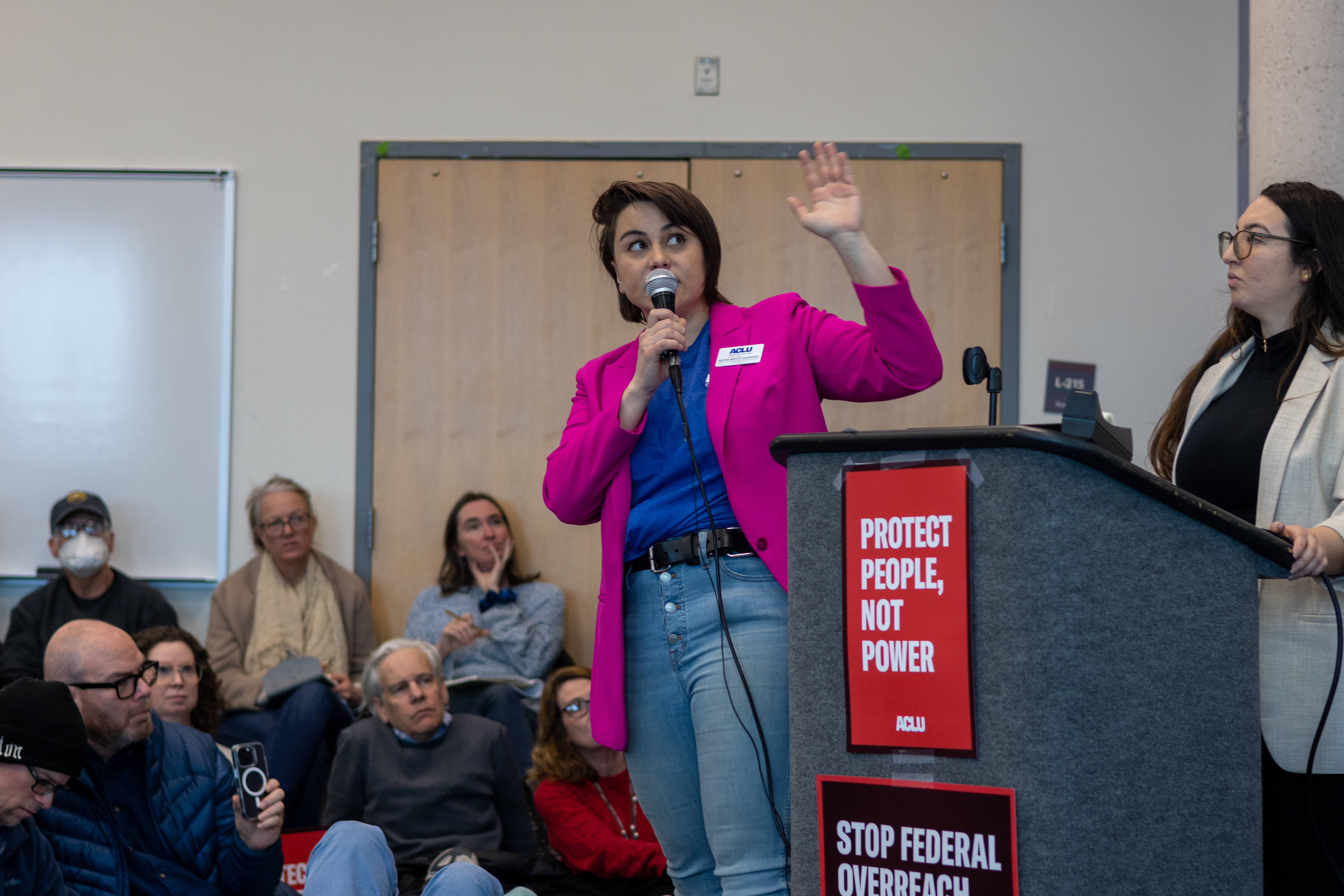 ACLU of Colorado director of advocacy speaking on a microphone at an activist event