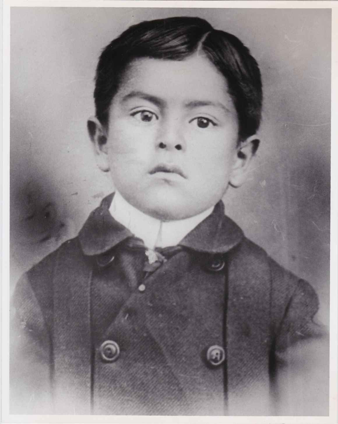 Black and white portrait photograph of a young child
